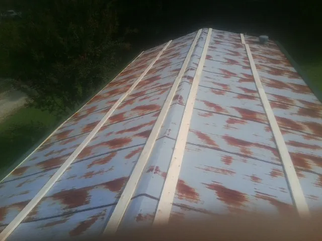 Rusted metal roof panels with new wood purlins before replacement — Storm Damage Roof Repair in Parsonsfield by Roofing Brothers