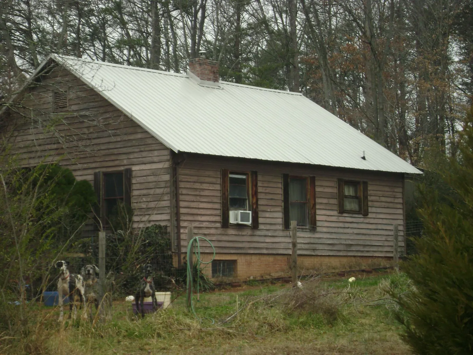 White metal roof on an old wood sided farmhouse, from a Metal Roof Installation job in Parsonsfield